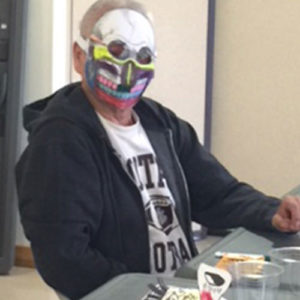 A Plymouth resident models the Dia de los Muertos mask they made
