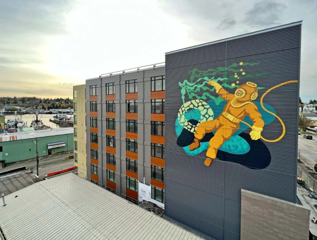 An image of a scuba diver on the side of a building. 