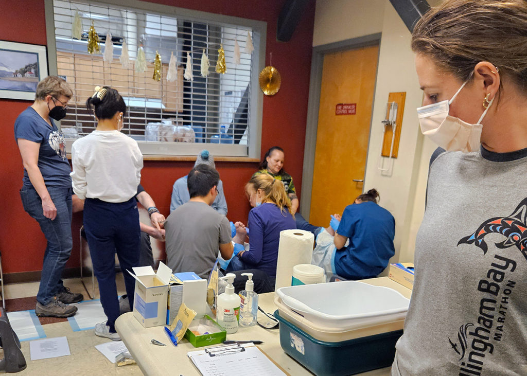 UW med students provide foot care to Plymouth Housing residents as part of a free health care clinic