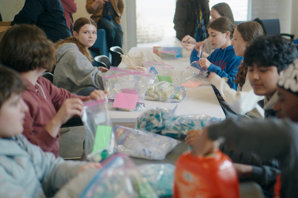 Groups of eighth graders from Seattle Academy joined us at Bob &amp; Marcia Almquist Place and Humphry House, helping assemble care kits for residents while learning about Plymouth's work.