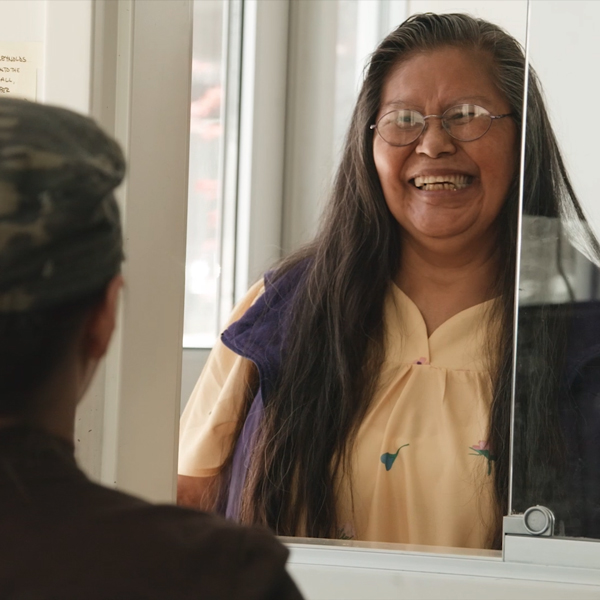 A Plymouth resident interacts with a staff member at the front desk