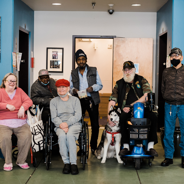 Residents of Plymouth's Simons Senior Apartments pose for a photo in the entryway