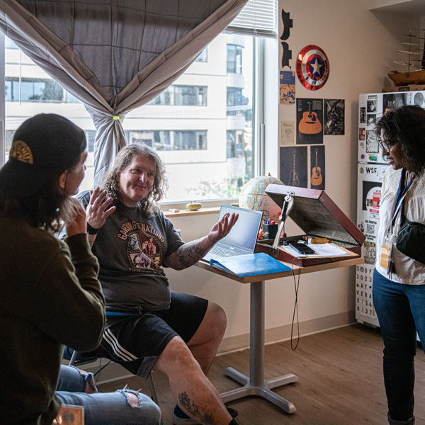 Plymouth staff meet with resident Kevin in his apartment