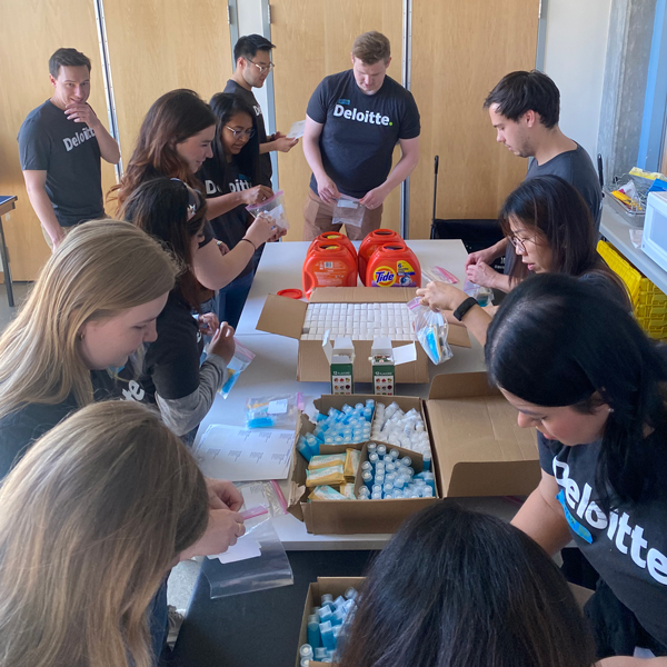 Deloitte staff members volunteer to assemble care kits for Plymouth Housing residents