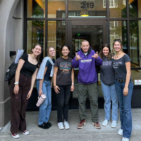 Volunteers pose with a Plymouth Housing resident