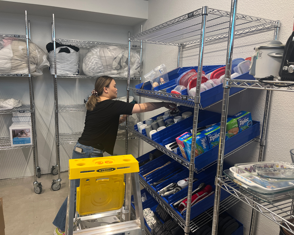 A volunteer stocks shelves at the Plymouth Supply Center