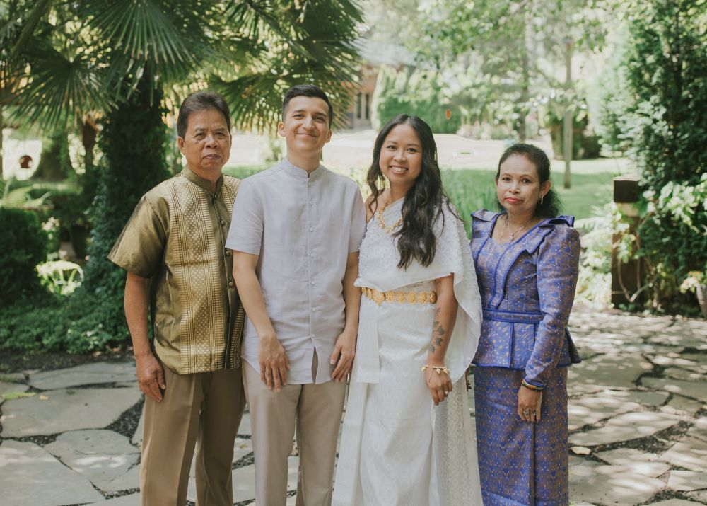 A family at a wedding in traditional Cambodian attire